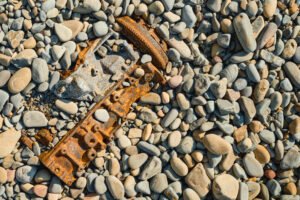 garbage on a clean wild beach, pollution of nature with industrial waste and other garbage on the seashore. dumping garbage into the ocean. ecological concept, top view